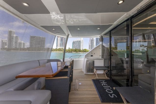 78ft SunSeeker Helios Miami smooth boarding with comfortable seating area and table.