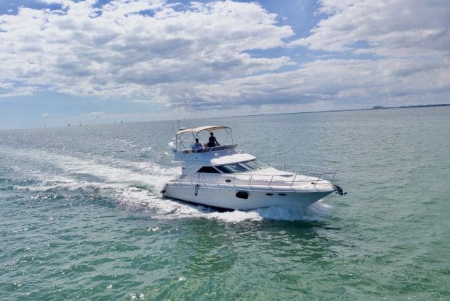Sea Ray 45ft Sea Daze Miami bow lounge area with breathtaking views of Biscayne Bay and the Miami skyline