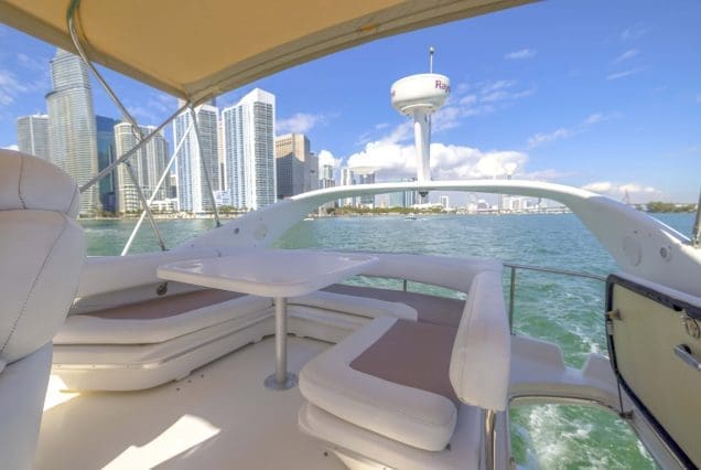 Sea Ray 45ft Sea Daze Miami upper deck seating with table for cocktails, dining, and celebrations